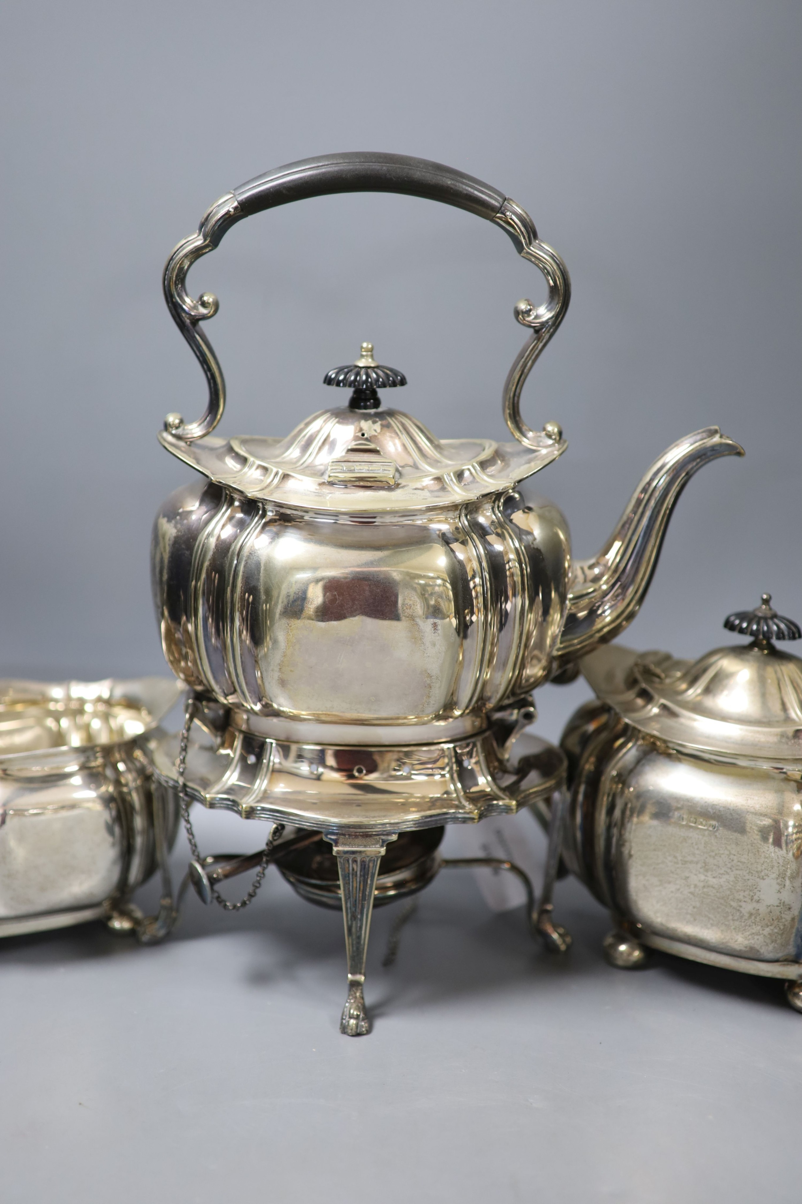 A George V silver three piece tea set, Cooper Brothers & Sons, Sheffield, 1913, gross 42oz, together with a similar plated tea kettle on stand with burner.